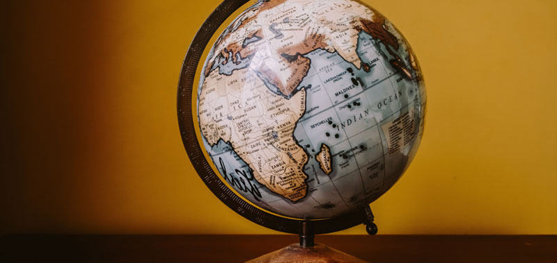 Photo of a globe on a desk  